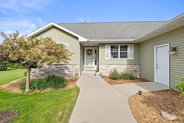 N5798 Lakeview Dr, Green Lake, WI 54941 - entrance to property featuring roof with shingles, a lawn, and stone siding