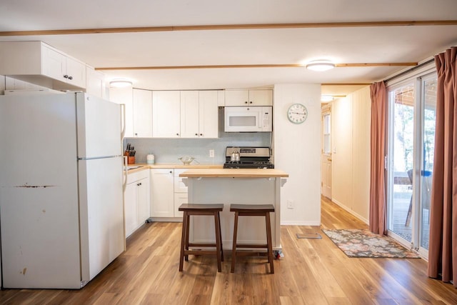 984 E Trout Valley Rd, Friendship, WI 54646 - kitchen featuring white appliances, wooden counters, white cabinets, and decorative backsplash