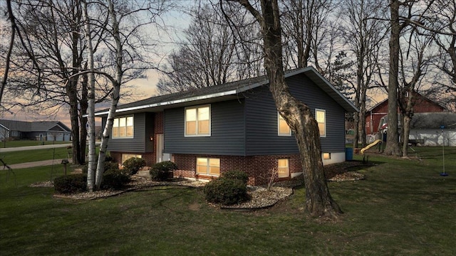 912 S 3rd Ave, Edgar, WI 54426 - property exterior at dusk featuring a yard and brick siding