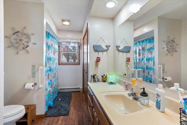 912 S 3rd Ave, Edgar, WI 54426 - full bath featuring a baseboard heating unit, wood finished floors, toilet, vanity, and curtained shower