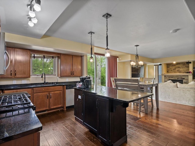 9318 W Mt Zion Dr, Milwaukee, WI 53224 - kitchen featuring a sink, dishwasher, brown cabinets, dark wood-style flooring, and a center island