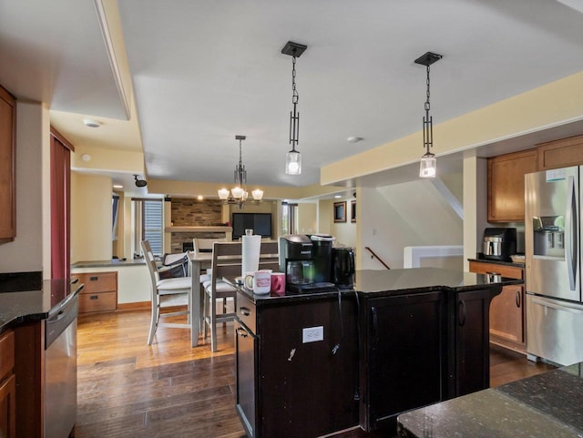 9318 W Mt Zion Dr, Milwaukee, WI 53224 - kitchen with stainless steel appliances, dark wood-style flooring, a chandelier, a center island, and pendant lighting