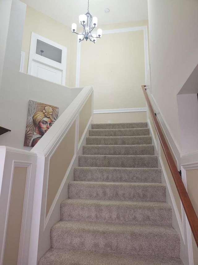 9318 W Mt Zion Dr, Milwaukee, WI 53224 - staircase with a chandelier and carpet