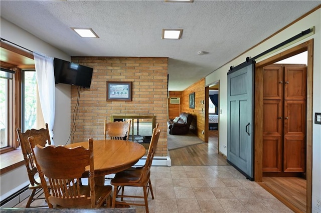 811 Russell St, Grantsburg, WI 54840 - dining space featuring a textured ceiling, a baseboard radiator, a barn door, and wood walls