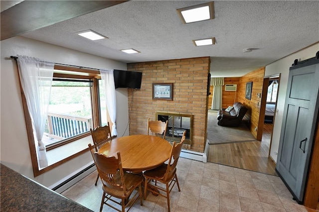 811 Russell St, Grantsburg, WI 54840 - dining room with a baseboard radiator, an AC wall unit, wooden walls, a barn door, and a brick fireplace