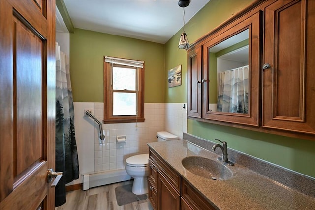 811 Russell St, Grantsburg, WI 54840 - bathroom featuring tile walls, toilet, a wainscoted wall, and vanity