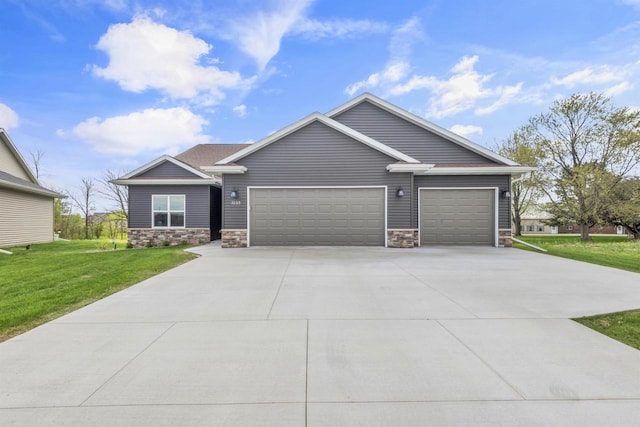 3153 Lazy Oak Ct, Green Bay, WI 54311 - view of front of house with stone siding, a garage, concrete driveway, and a front lawn