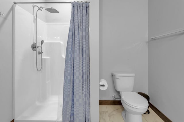 3153 Lazy Oak Ct, Green Bay, WI 54311 - bathroom with a stall shower, toilet, marble finish flooring, and baseboards
