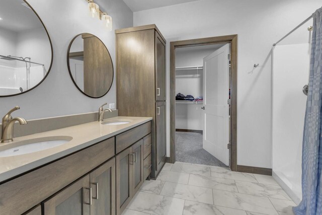 3153 Lazy Oak Ct, Green Bay, WI 54311 - full bathroom with marble finish floors, a shower, a walk in closet, double vanity, and baseboards