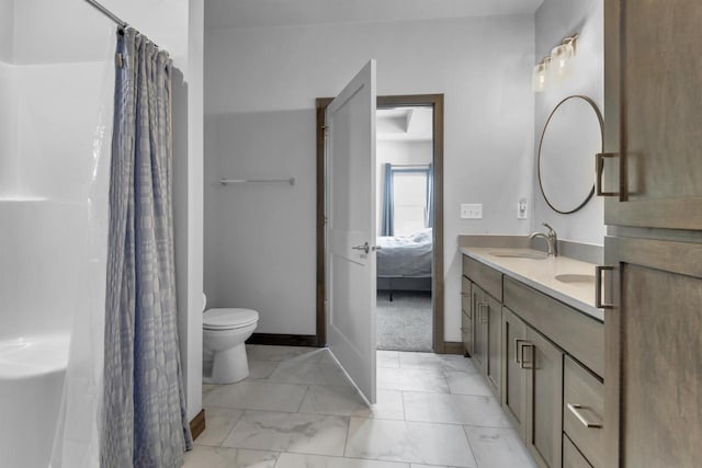 3153 Lazy Oak Ct, Green Bay, WI 54311 - full bath with toilet, double vanity, marble look tile flooring, connected bathroom, and baseboards