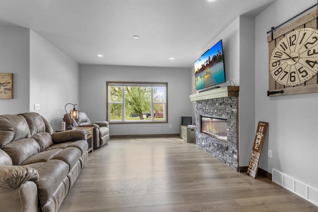 3153 Lazy Oak Ct, Green Bay, WI 54311 - living area with a fireplace, wood finished floors, recessed lighting, baseboards, and a barn door