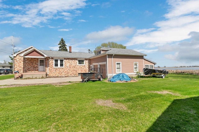 rear view of property with a yard and a chimney