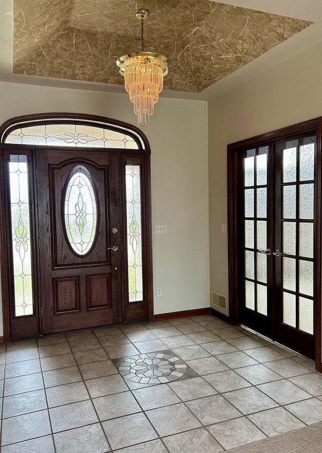 1120 Cardinal St, De Pere, WI 54115 - entrance foyer with a chandelier, baseboards, light tile patterned floors, and french doors