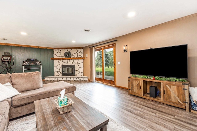 11915 Wedgewood Ln, Darlington, WI 53530 - living area with wood finished floors, crown molding, a stone fireplace, recessed lighting, and baseboards