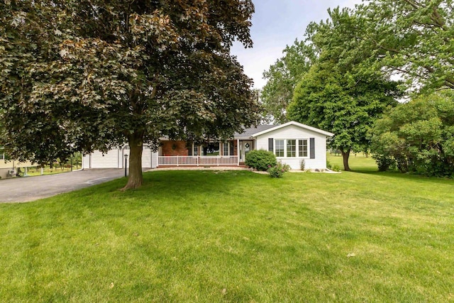 11915 Wedgewood Ln, Darlington, WI 53530 - view of front of home featuring asphalt driveway, an attached garage, a front yard, and a porch
