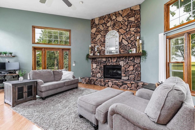 11915 Wedgewood Ln, Darlington, WI 53530 - living area with wood finished floors, a high ceiling, ceiling fan, and a stone fireplace