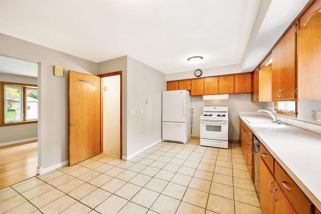 605 Douglas Trl, Madison, WI 53716 - kitchen featuring white appliances, a sink, light countertops, brown cabinetry, and under cabinet range hood