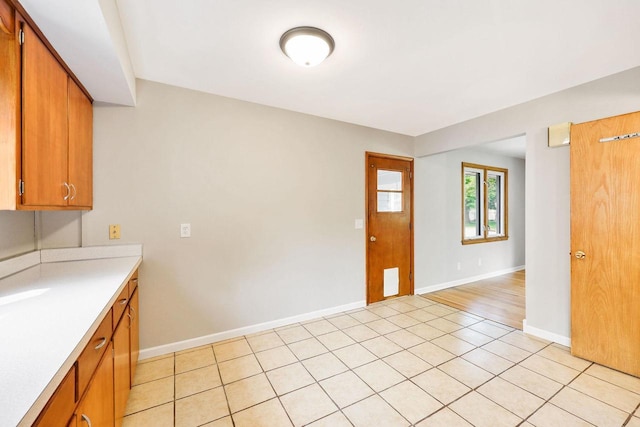 605 Douglas Trl, Madison, WI 53716 - kitchen featuring light countertops, brown cabinetry, and baseboards