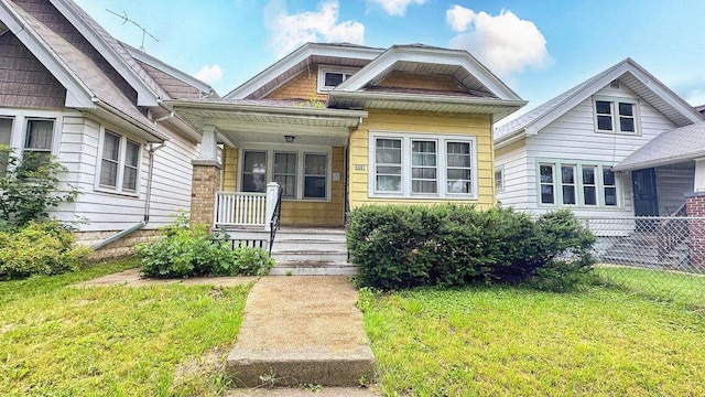 5561 N 40th St, Milwaukee, WI 53209 - view of front facade with covered porch and a front lawn