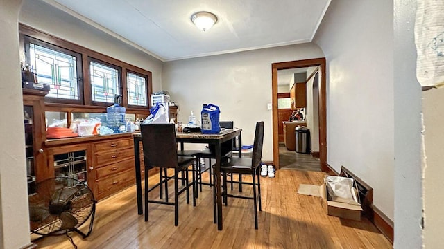 5561 N 40th St, Milwaukee, WI 53209 - dining space with light wood-style floors, ornamental molding, and baseboards