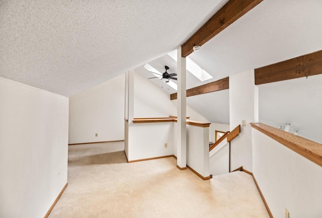 901 Duck Pond Rd, Fontana, WI 53125 - additional living space with a skylight, light colored carpet, baseboards, and a textured ceiling