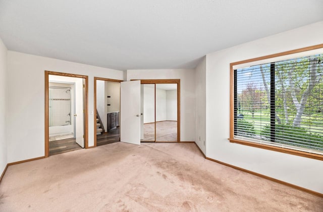 901 Duck Pond Rd, Fontana, WI 53125 - unfurnished bedroom featuring carpet floors, baseboards, and ensuite bathroom