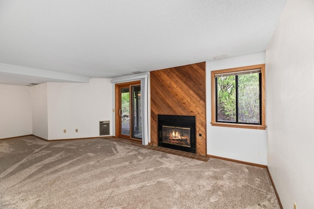 901 Duck Pond Rd, Fontana, WI 53125 - unfurnished living room with carpet flooring, a fireplace, baseboards, and wood walls