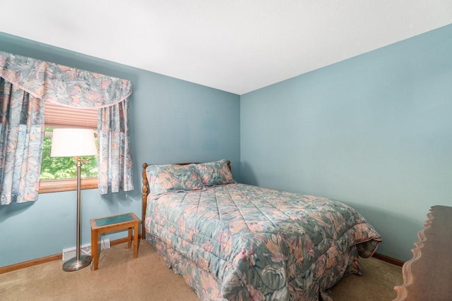 carpeted bedroom featuring baseboards