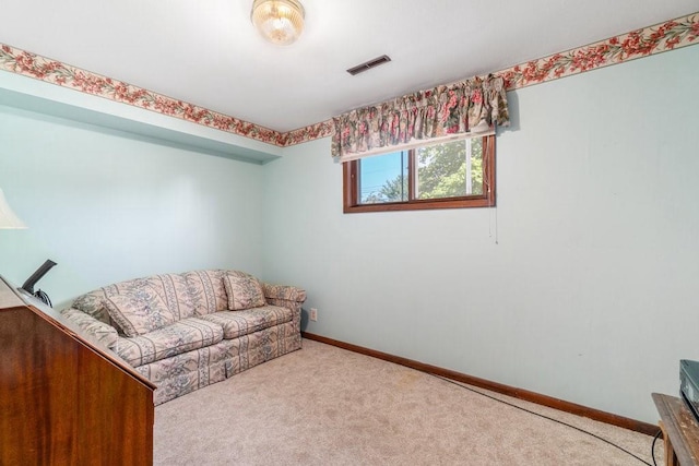 sitting room featuring carpet floors and baseboards