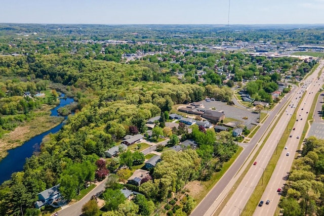 aerial view of property's location featuring a main thoroughfare and a large body of water