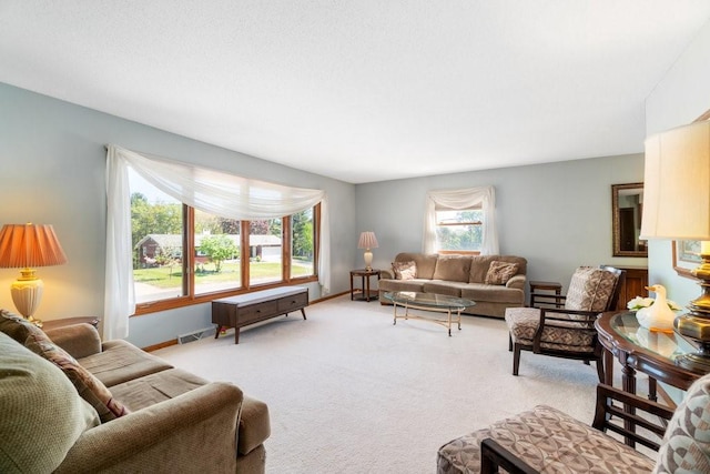 living room with light carpet and baseboards