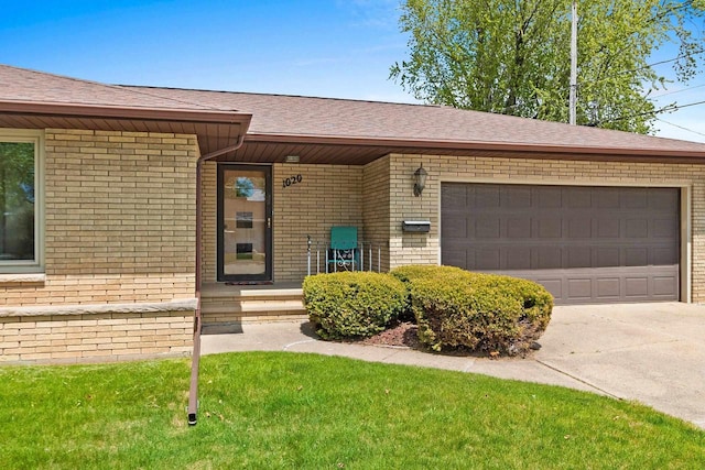 1020 W 3rd St, Kimberly, WI 54136 - view of front of home with brick siding, driveway, an attached garage, and roof with shingles