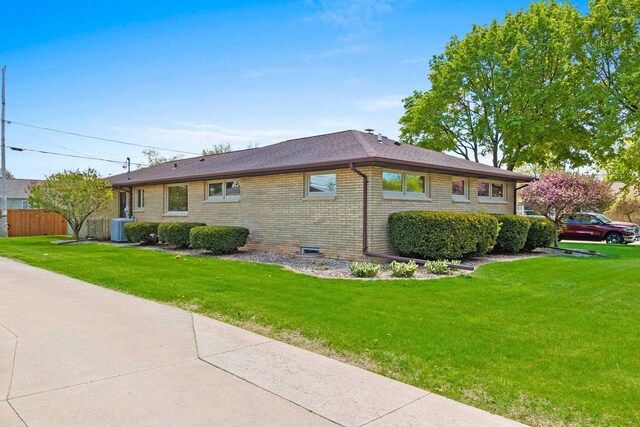 1020 W 3rd St, Kimberly, WI 54136 - view of side of home featuring brick siding, cooling unit, a yard, and a shingled roof