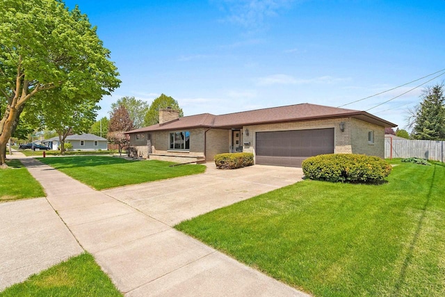 1020 W 3rd St, Kimberly, WI 54136 - view of front of home with brick siding, an attached garage, driveway, and a chimney