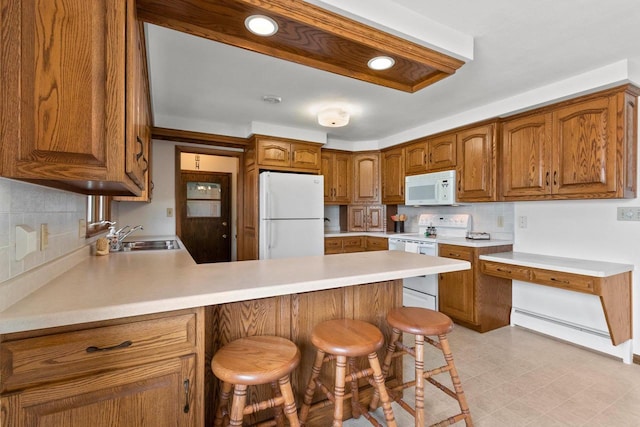 1020 W 3rd St, Kimberly, WI 54136 - kitchen with white appliances, a sink, a peninsula, tasteful backsplash, and light countertops