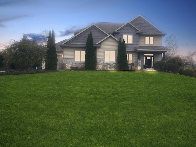 5634 Wind Dancer Ct, Sheboygan, WI 53081 - craftsman house with a yard, stone siding, and a shingled roof