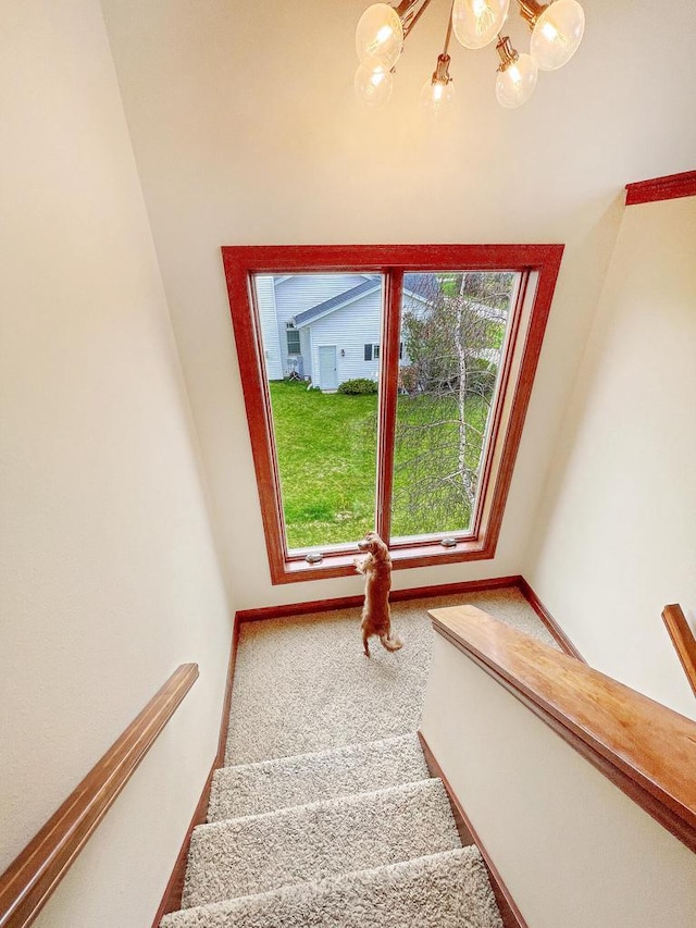 5634 Wind Dancer Ct, Sheboygan, WI 53081 - staircase featuring a chandelier, carpet, and baseboards