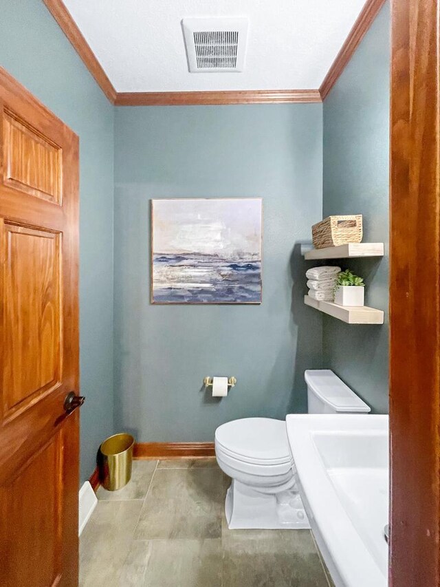 5634 Wind Dancer Ct, Sheboygan, WI 53081 - half bathroom featuring crown molding, toilet, and baseboards