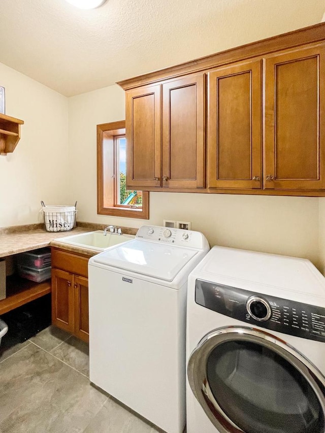 5634 Wind Dancer Ct, Sheboygan, WI 53081 - washroom with washing machine and clothes dryer, cabinet space, and light tile patterned flooring