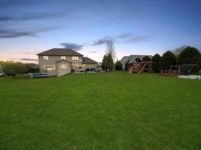 5634 Wind Dancer Ct, Sheboygan, WI 53081 - view of grassy yard featuring a trampoline and a playground