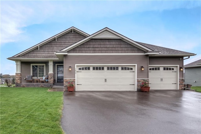 1215 Brooke Ct, Chippewa Falls, WI 54729 - craftsman-style home with stone siding, asphalt driveway, an attached garage, and a front yard