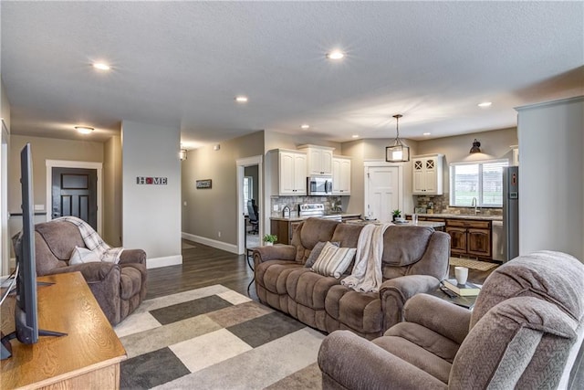 1215 Brooke Ct, Chippewa Falls, WI 54729 - living room featuring recessed lighting, baseboards, and dark wood finished floors