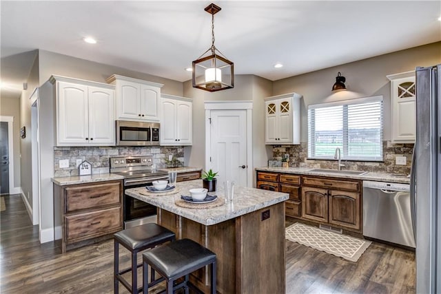 1215 Brooke Ct, Chippewa Falls, WI 54729 - kitchen with a sink, appliances with stainless steel finishes, white cabinets, dark wood finished floors, and recessed lighting