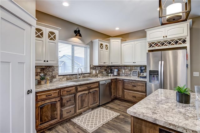 1215 Brooke Ct, Chippewa Falls, WI 54729 - kitchen featuring a sink, stainless steel appliances, white cabinetry, dark wood finished floors, and tasteful backsplash