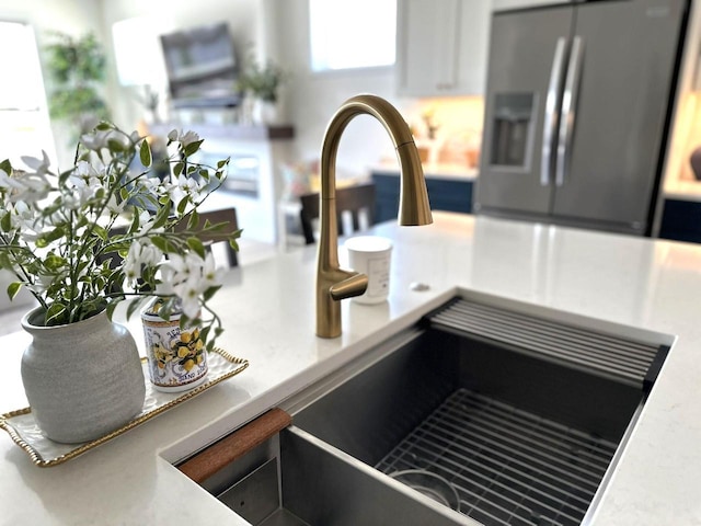 265 Victory Ln, Elkhart Lake, WI 53020 - kitchen view of stainless steel refrigerator with ice dispenser, a sink, and light countertops