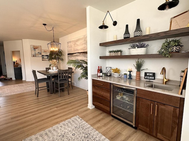 265 Victory Ln, Elkhart Lake, WI 53020 - indoor dry bar with wine cooler, light wood-style floors, a chandelier, baseboards, and pendant lighting