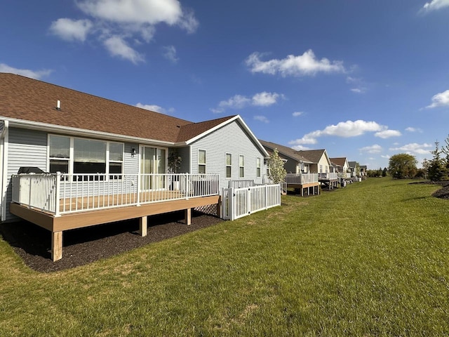 265 Victory Ln, Elkhart Lake, WI 53020 - back of house featuring a wooden deck, a yard, and a shingled roof