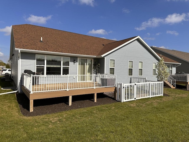 265 Victory Ln, Elkhart Lake, WI 53020 - rear view of property featuring a wooden deck, a lawn, and roof with shingles