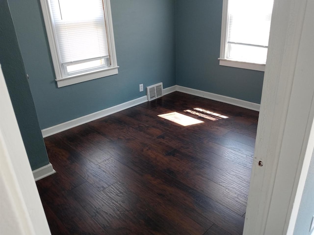 1445 Bayliss Ave, Beloit, WI 53511 - unfurnished room with healthy amount of natural light, wood finished floors, and baseboards