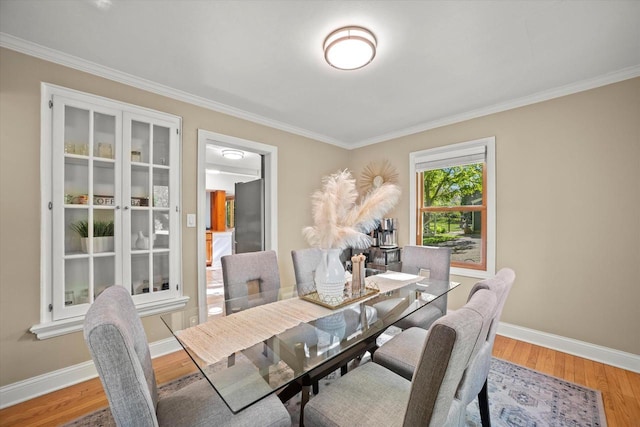 530 W Acacia Rd, Glendale, WI 53217 - dining space featuring crown molding, baseboards, and light wood-style floors